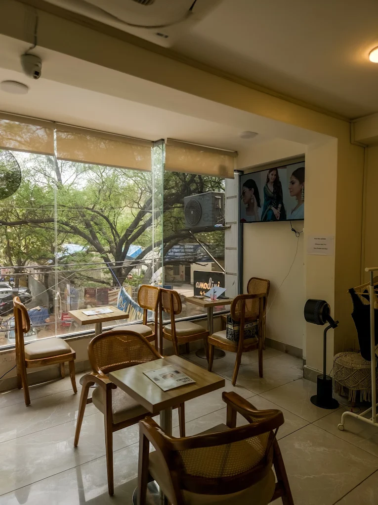 Alayna Cafe Shahpur Jat — window seating with garden view